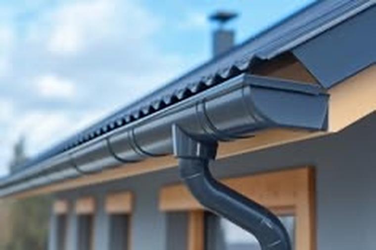 Continuous seamless gutter run along the eave with a downspout